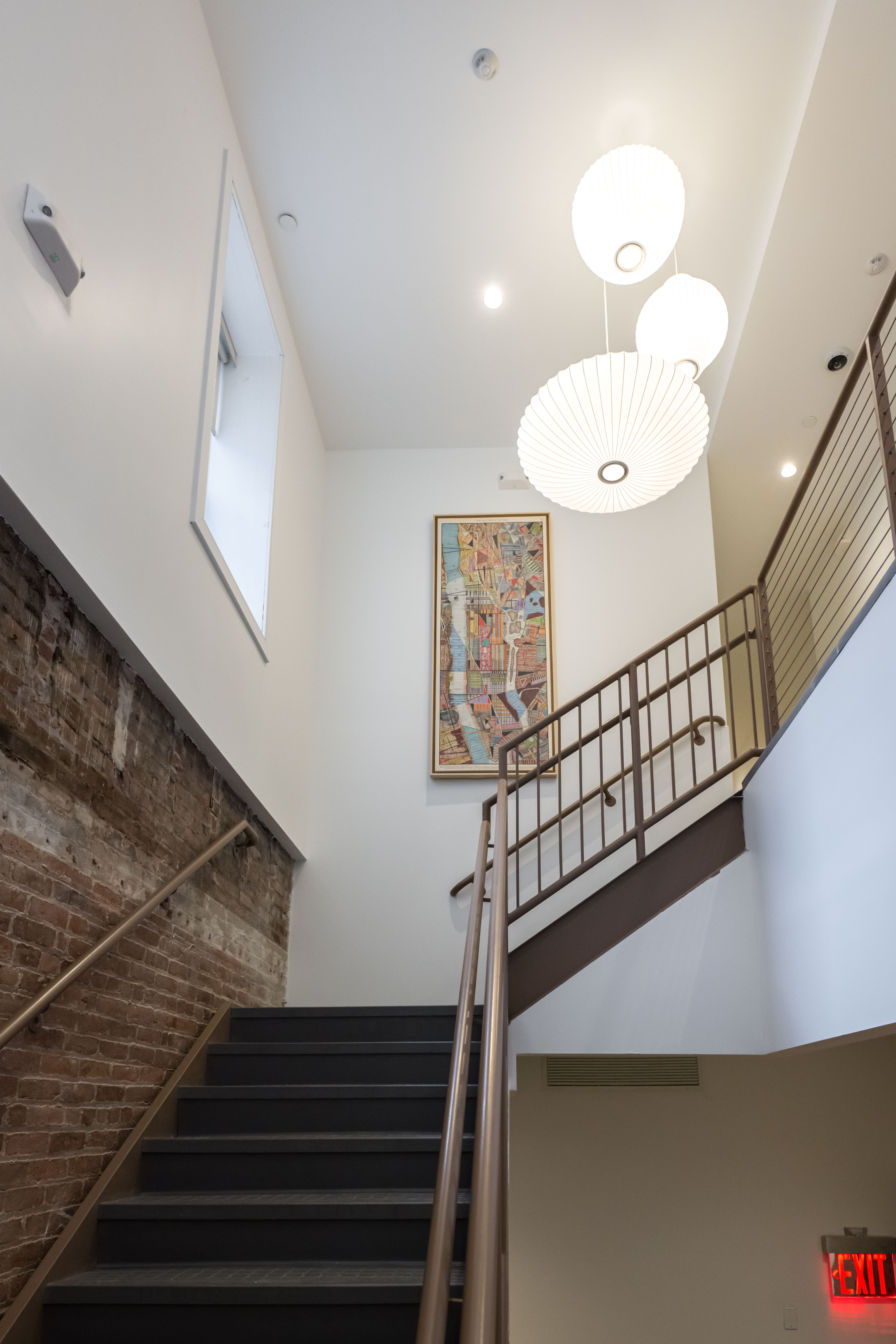 A stairway with a bright lantern light fixture